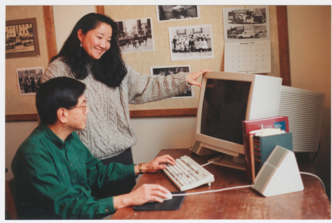 Becky Fukuda and staff member working on computer (ddr-densho-506-66)