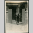 Woman poses by front gate (ddr-densho-359-847)