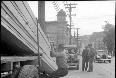 Man unloading lumber from truck (ddr-densho-426-2170)