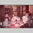 Agnes and Chester Sakura and family around restaurant table (ddr-densho-523-588)
