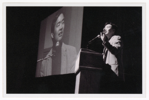 Tom Ikeda speaking at Day of Rememberance (ddr-densho-506-17)