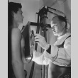 Former Californian Dr. Fugikawa examining a patient (ddr-csujad-14-14)