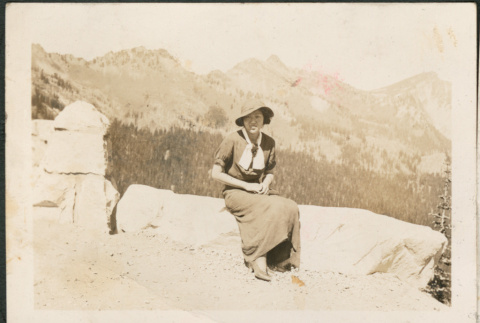 Woman sitting stone wall (ddr-densho-316-88)