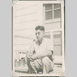 Man sitting on steps (ddr-densho-493-112)
