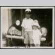 Two boys pose in front of a car (ddr-densho-359-952)