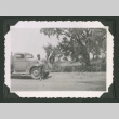 Shirtless man leaning against truck (ddr-densho-471-175)