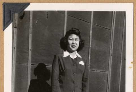 Woman standing in a dark suit (ddr-densho-542-294)
