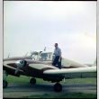 Man standing on wing of small plane (ddr-densho-377-1439)