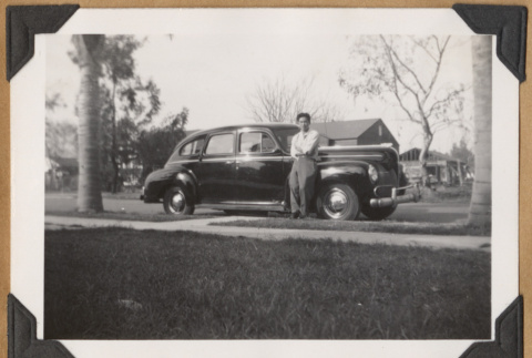 Man leaning against car (ddr-densho-542-163)