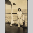Woman standing by railing aboard ship (ddr-densho-426-1796)