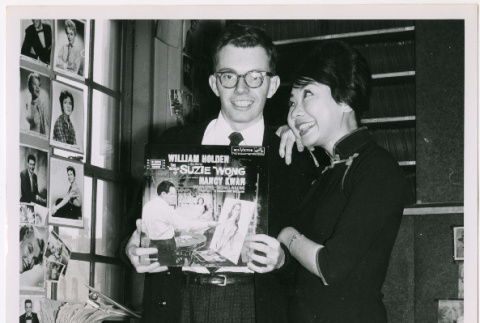 Mary Mon Toy with man holding album soundtrack for The World of Suzie Wong film (ddr-densho-367-195)