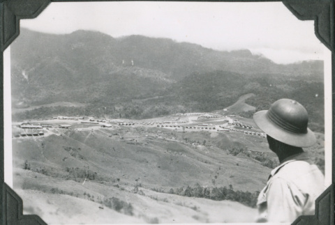 Man looking at camp on hillside from above (ddr-ajah-2-623)