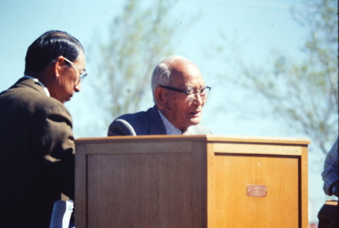A man speaking at a remembrance program (ddr-densho-294-67)