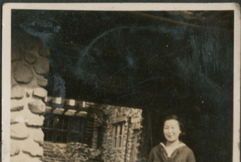 Woman standing outside stone house (ddr-densho-316-170)