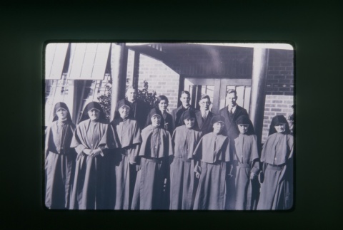 (Slide) - Image of nuns and priests outside Maryknoll (ddr-densho-330-100-master-d40769f4fc)