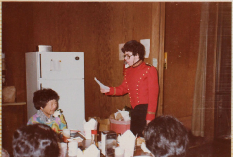 Man in telegram messenger costume reading note out loud (ddr-densho-426-1332)