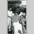 Unidentified people-one in wheel chair, garden, Manzanar hospital (ddr-densho-343-118)