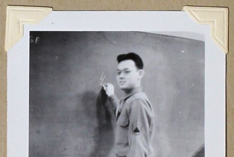 Man in military uniform at a chalkboard (ddr-densho-404-388)