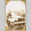 Group sitting at picnic table (ddr-densho-383-310)