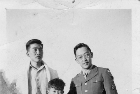Two Nisei men and a boy in a concentration camp (ddr-densho-154-3)