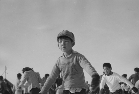 Young former California boy learning to ice skate at Heart Mountain incarceration camp (ddr-csujad-14-58)