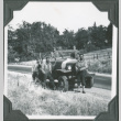 Men standing next to truck on side of road (ddr-ajah-2-206)