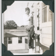 Man climbing ladder on side of building (ddr-ajah-2-396)