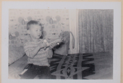 Peter playing with toy helicopter (ddr-densho-462-267)