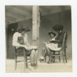 Nisei women reading outside barrack (ddr-csujad-44-46)