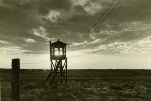 Guard tower and barbed wire (ddr-densho-159-11)
