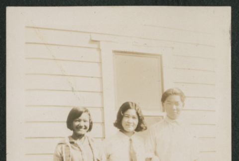three teens in front of house (ddr-densho-378-587)