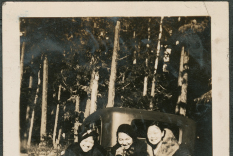 Three women next to car (ddr-densho-316-331)