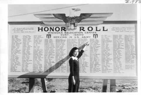 Japanese American pointing at Honor Roll sign (ddr-densho-37-748)