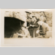 Two women and three men around outside fireplace (ddr-densho-426-1996)