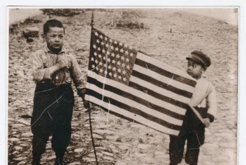 Two children with an American flag (ddr-densho-1007-322)