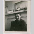 Man in front of fireplace mantle (ddr-densho-329-815)