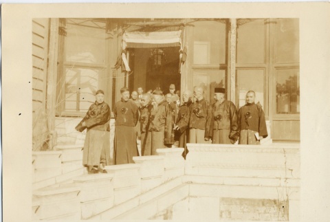A group of men standing outside a building (ddr-njpa-6-8)
