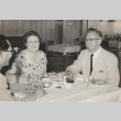 Woman and two men seated at a table (ddr-njpa-2-1135)