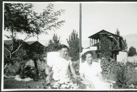Photograph of Peter Hondo and Thelma McBride in a park at Manzanar (ddr-csujad-47-252)