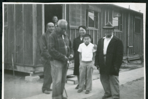 Photograph of people in front of a barracks at Manzanar (ddr-csujad-47-333)