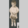 Cutout photo of child holding a purse (ddr-densho-483-535)