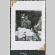 Man sitting at a table eating a burger (ddr-densho-434-218)