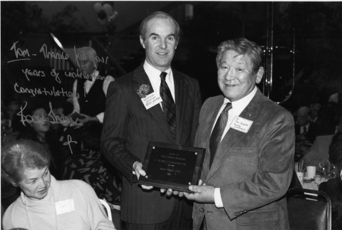 Tom accepting an award from Booth Gardner for the Kubota Gardening Company.  Amy Kubota also in the photo (ddr-densho-354-133)