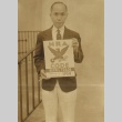 Colbert Kurokawa posing with NRA sign (ddr-njpa-4-350)