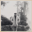 Man standing by stone wall (ddr-densho-522-119)