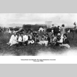 Group sitting in field with tents in background (ddr-ajah-6-116)