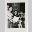 Mary Mon Toy with two cast mates looking at a script (ddr-densho-367-297)