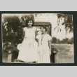 2 women in front of a car (ddr-densho-378-686)