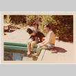 Tomoye and Henri Takahashi by swimming pool, holding dog (ddr-densho-426-1103)