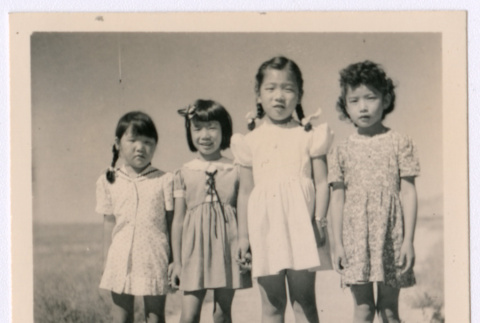 Four Japanese American girls standing in a row (ddr-densho-362-27)